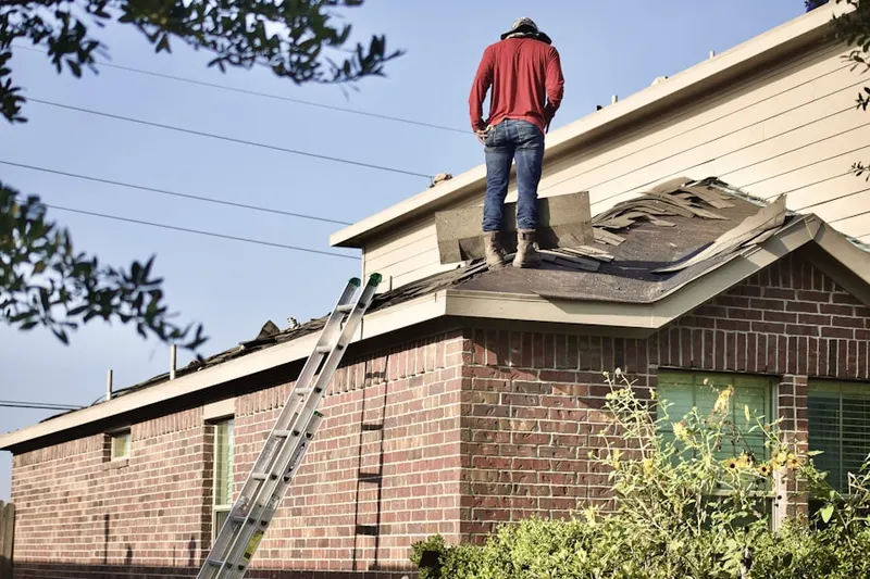 Professional roofer working on a residential roof in McEver